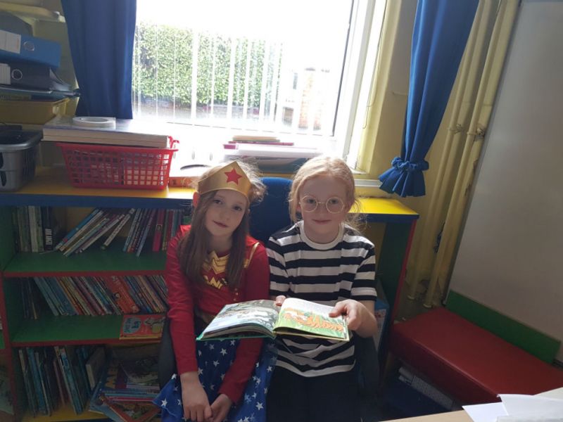 Gangsta Granny and Wonderwoman reading together.